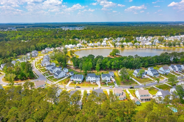 bird's eye view featuring a residential view, a water view, and a wooded view