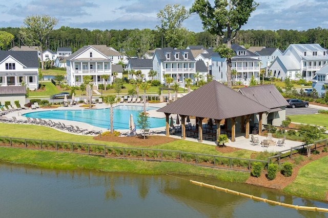 drone / aerial view featuring a water view and a residential view