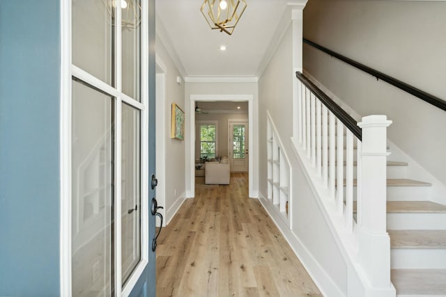 interior space featuring light wood finished floors, recessed lighting, stairway, ornamental molding, and baseboards