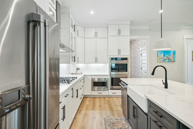 kitchen with stainless steel appliances, white cabinetry, glass insert cabinets, and decorative backsplash