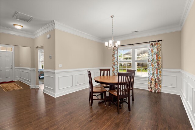 207 Brutus Ln, Summerville, SC 29485 - dining area featuring ornamental molding, a chandelier, dark wood finished floors, wainscoting, and a decorative wall