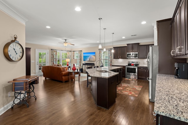 207 Brutus Ln, Summerville, SC 29485 - kitchen with stainless steel appliances, open floor plan, a sink, dark brown cabinetry, and dark wood-type flooring