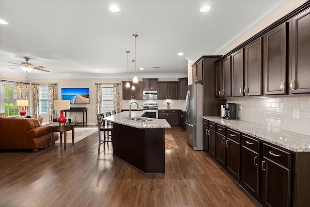 207 Brutus Ln, Summerville, SC 29485 - kitchen featuring stainless steel appliances, a sink, open floor plan, dark brown cabinetry, and ceiling fan