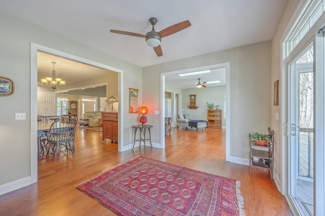 entryway with a wealth of natural light, baseboards, and wood finished floors