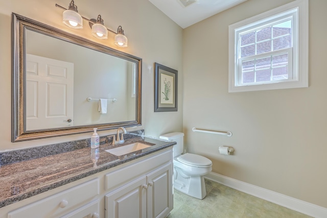 half bathroom with visible vents, baseboards, toilet, tile patterned floors, and vanity