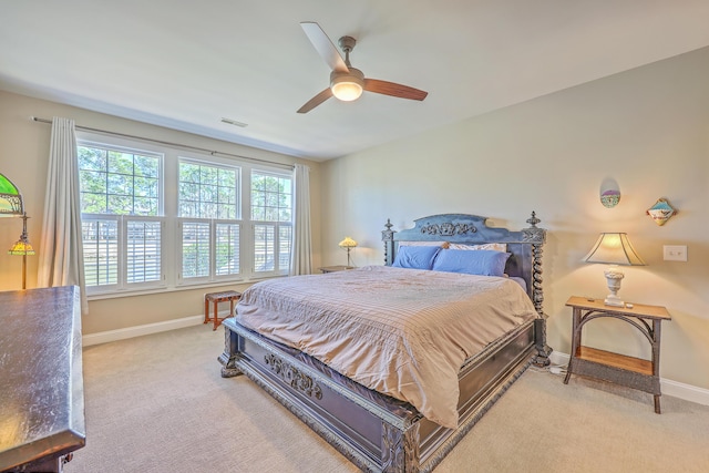 bedroom with baseboards, visible vents, ceiling fan, and light colored carpet