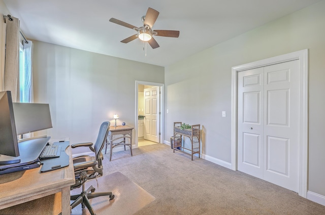 office area with light carpet, ceiling fan, and baseboards