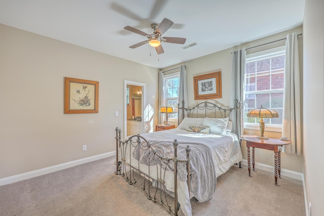 bedroom with visible vents, baseboards, ceiling fan, ensuite bathroom, and carpet