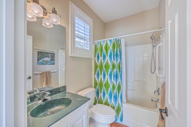 bathroom featuring toilet, shower / bath combo with shower curtain, and vanity