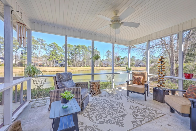 sunroom with a water view, plenty of natural light, and ceiling fan