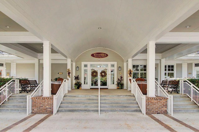 entrance to property with a porch and french doors