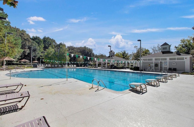 community pool with fence and a patio