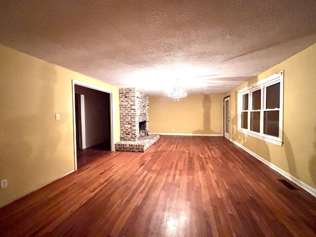 1871 Grimball Rd, Charleston, SC 29412 - unfurnished living room with wood finished floors, a textured ceiling, a brick fireplace, a chandelier, and baseboards
