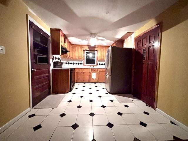 1871 Grimball Rd, Charleston, SC 29412 - kitchen featuring black range with electric cooktop, freestanding refrigerator, ceiling fan, under cabinet range hood, and a sink