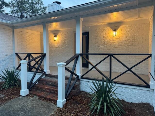 doorway to property featuring a porch