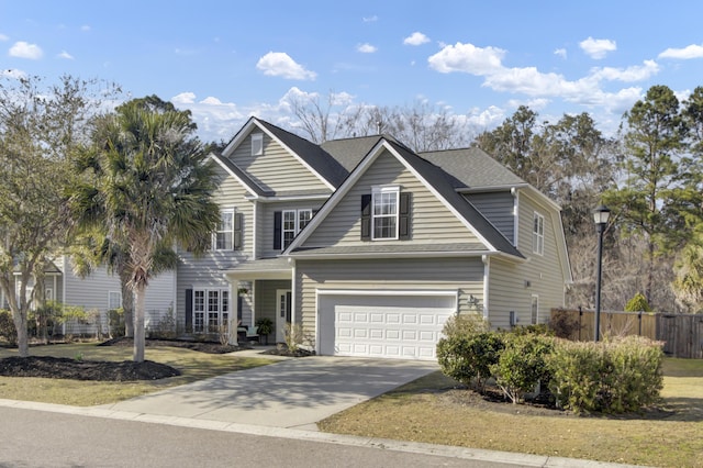 view of front of house featuring a garage, driveway, roof with shingles, and fence