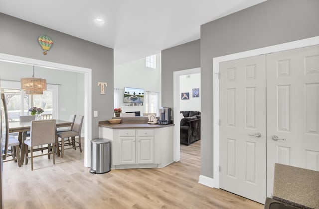 kitchen with dark countertops, light wood-style floors, and white cabinetry