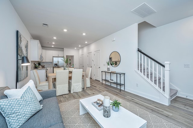 804 Twin Rivers Dr, Wando, SC 29492 - living room with stairway, light wood-type flooring, recessed lighting, and baseboards
