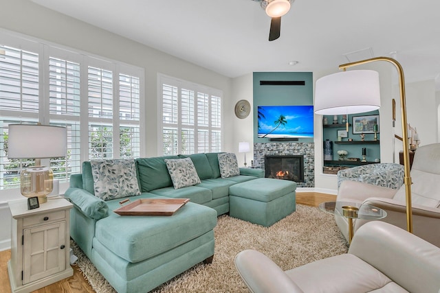 134 Etiwan Park St, Charleston, SC 29492 - living area with wood finished floors, a ceiling fan, a tiled fireplace, and baseboards