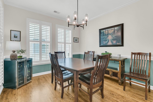 134 Etiwan Park St, Charleston, SC 29492 - dining room featuring light wood finished floors, a chandelier, crown molding, plenty of natural light, and beverage cooler