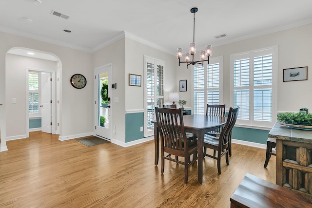 134 Etiwan Park St, Charleston, SC 29492 - dining room featuring light wood-style floors, arched walkways, a chandelier, ornamental molding, and baseboards