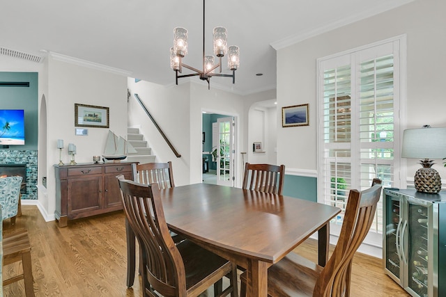 134 Etiwan Park St, Charleston, SC 29492 - dining room featuring ornamental molding, a chandelier, light wood finished floors, a fireplace, and stairs
