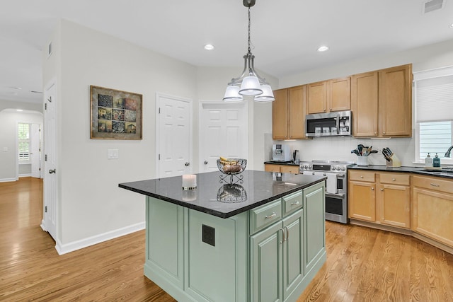 134 Etiwan Park St, Charleston, SC 29492 - kitchen with stainless steel appliances, arched walkways, light wood-style flooring, baseboards, and plenty of natural light