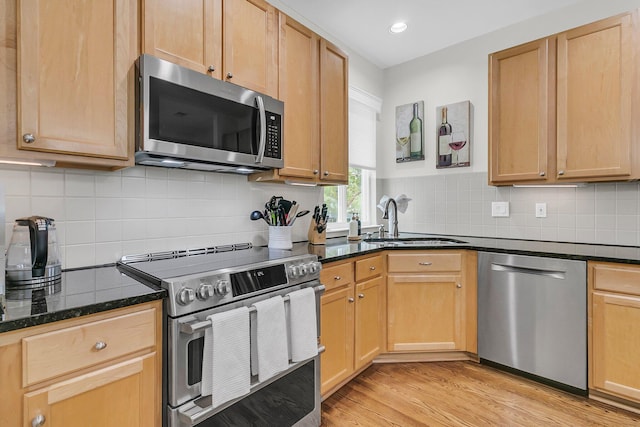 134 Etiwan Park St, Charleston, SC 29492 - kitchen with stainless steel appliances, a sink, dark stone counters, light wood finished floors, and tasteful backsplash