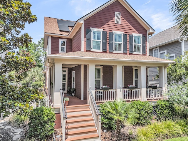 134 Etiwan Park St, Charleston, SC 29492 - view of front of house featuring covered porch, roof mounted solar panels, and a shingled roof