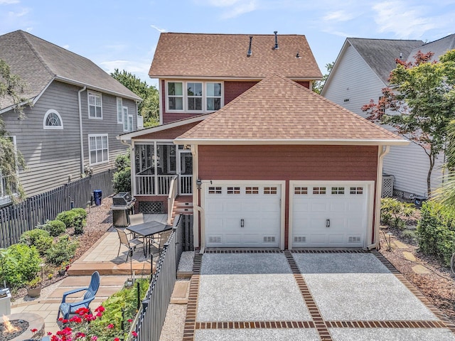 134 Etiwan Park St, Charleston, SC 29492 - view of front of house featuring a shingled roof, a sunroom, driveway, a garage, and a patio