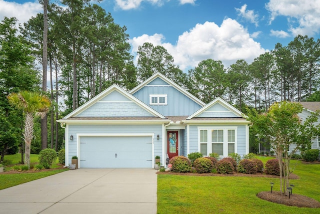 259 Camber Rd, Huger, SC 29450 - view of front of home featuring driveway, an attached garage, a front lawn, and board and batten siding