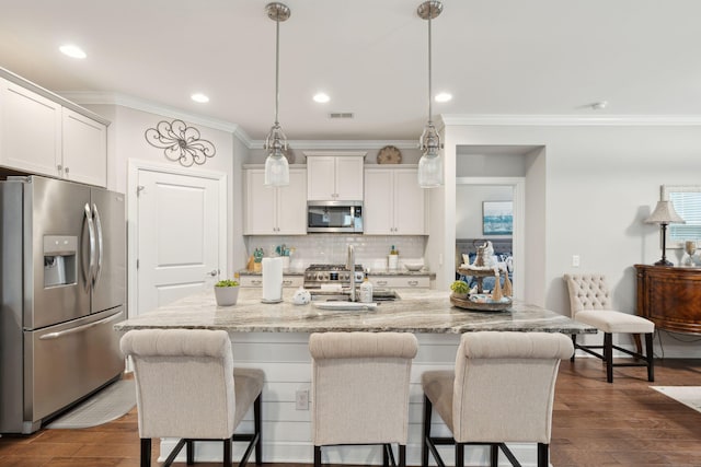 259 Camber Rd, Huger, SC 29450 - kitchen featuring stainless steel appliances, ornamental molding, a kitchen bar, a sink, and decorative backsplash