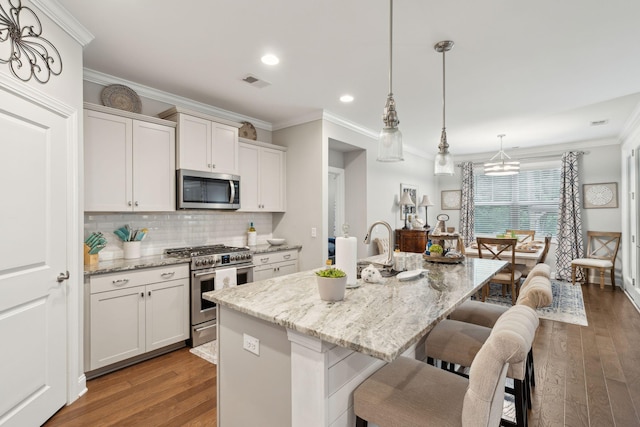 259 Camber Rd, Huger, SC 29450 - kitchen with appliances with stainless steel finishes, wood finished floors, a breakfast bar, crown molding, and backsplash