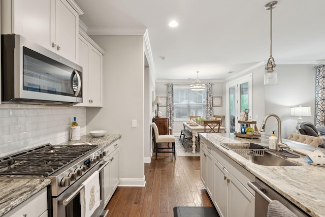 259 Camber Rd, Huger, SC 29450 - kitchen with appliances with stainless steel finishes, a sink, crown molding, backsplash, and white cabinets