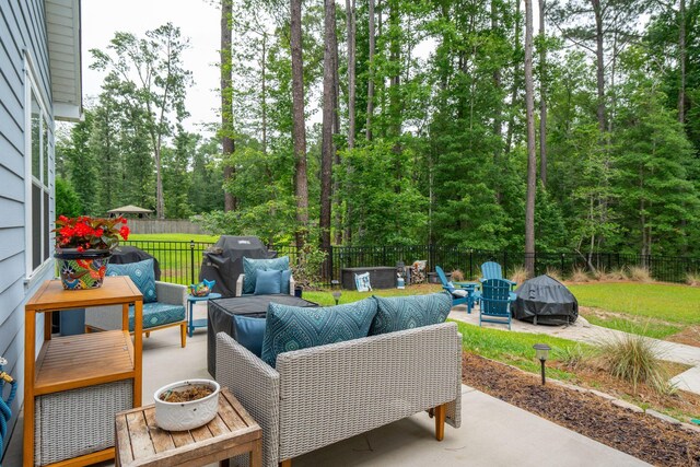 259 Camber Rd, Huger, SC 29450 - fenced backyard featuring an outdoor living space with a fire pit, a patio area, and area for grilling