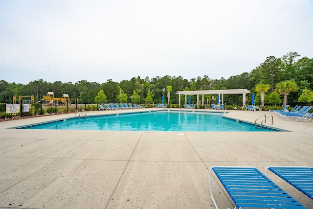 259 Camber Rd, Huger, SC 29450 - community pool featuring a patio area, a pergola, and view of wooded area