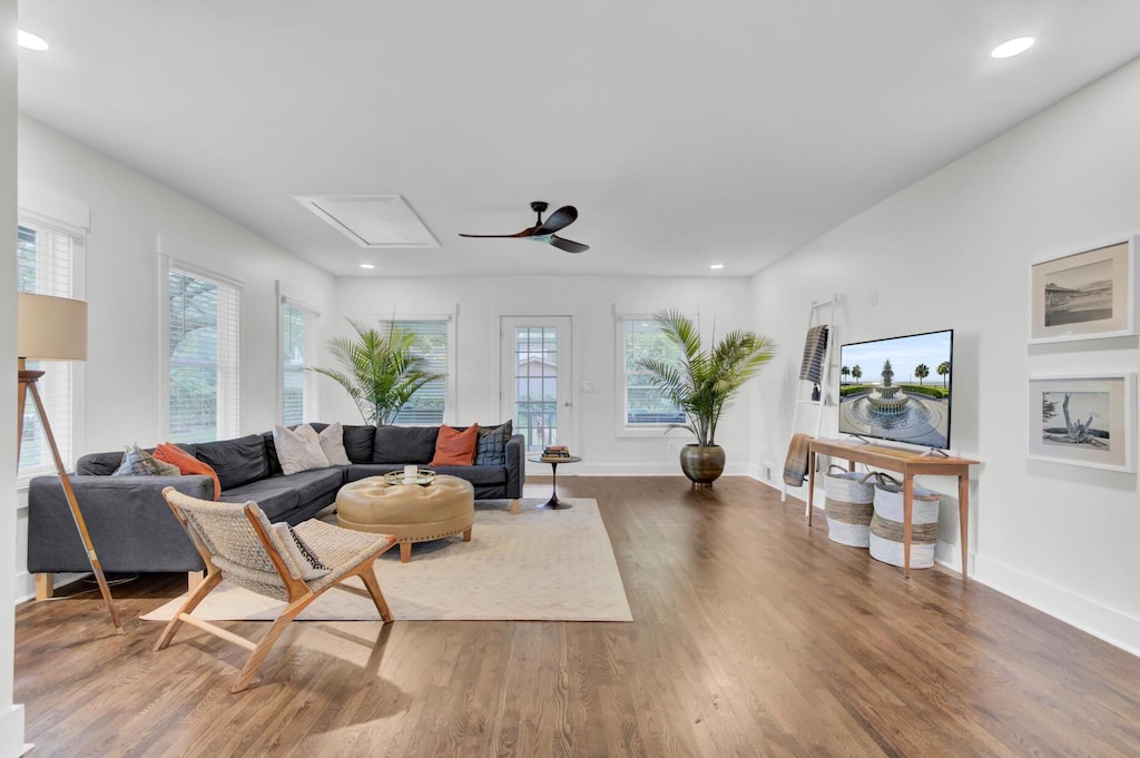 living room featuring ceiling fan and dark hardwood / wood-style floors