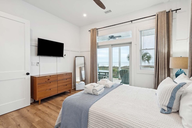 bedroom with ceiling fan, light wood-style flooring, visible vents, and access to exterior