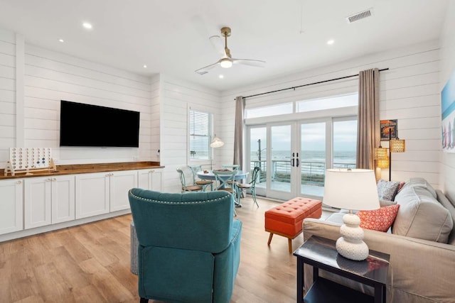 living room with recessed lighting, light wood-style flooring, ceiling fan, and french doors