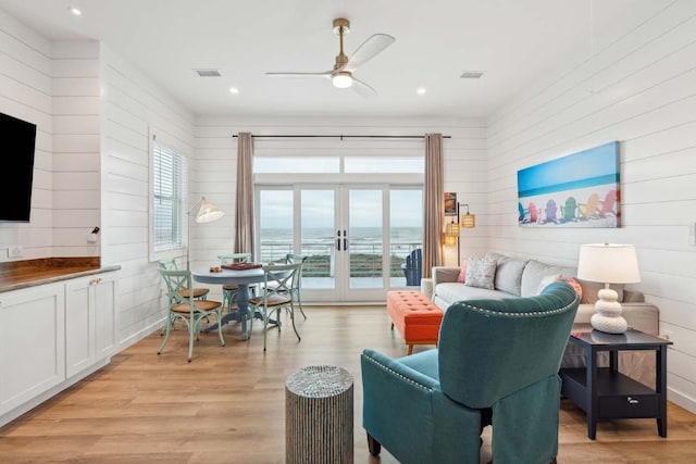 living area featuring french doors, light wood finished floors, a ceiling fan, and recessed lighting