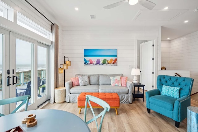 living area with attic access, wood finished floors, and recessed lighting