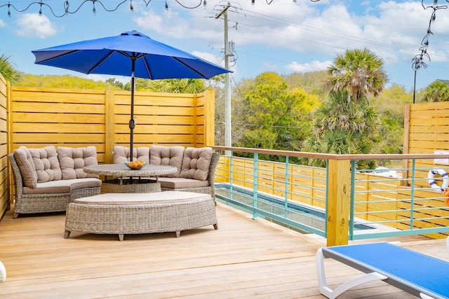 wooden terrace featuring outdoor lounge area