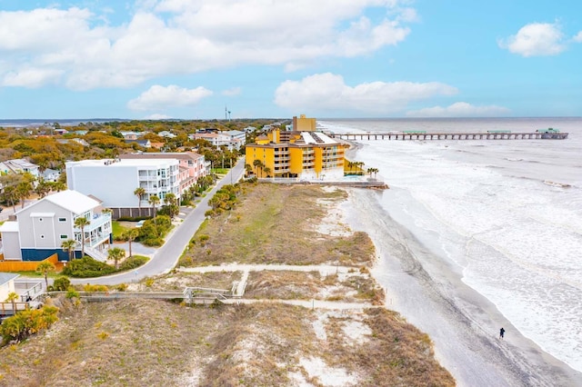 birds eye view of property featuring a water view and a beach view