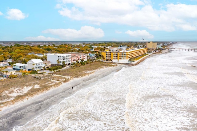 birds eye view of property featuring a beach view and a water view