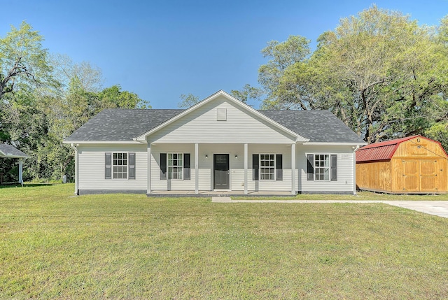 view of front of house featuring roof with shingles, a front yard, a porch, an outbuilding, and a storage unit