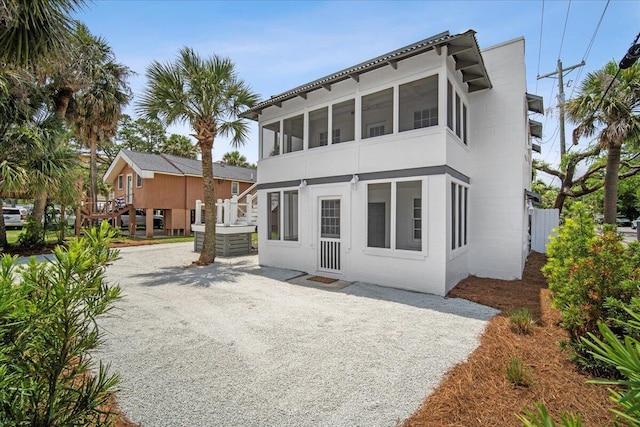 back of property with gravel driveway