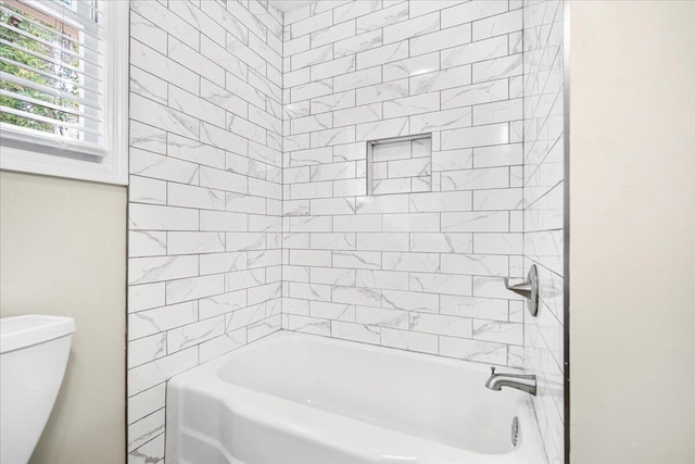 bathroom featuring shower / washtub combination and toilet