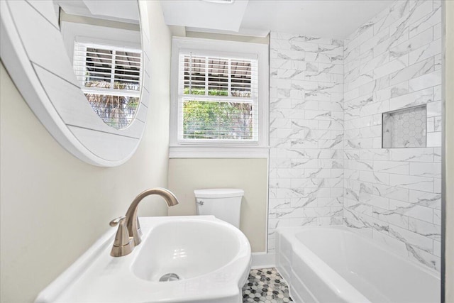 full bathroom featuring toilet, baseboards, and bathing tub / shower combination