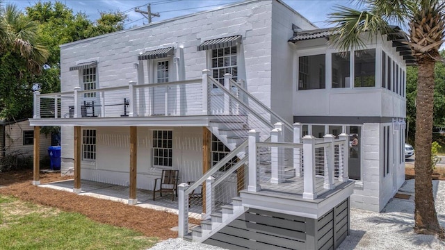 view of front facade with stairway and a wooden deck