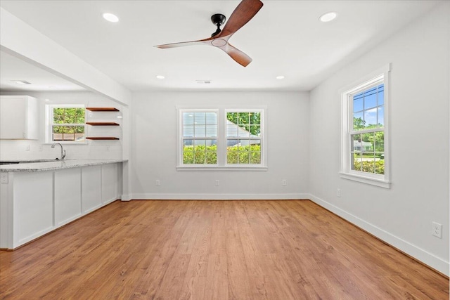 1430 E Montague Ave, North Charleston, SC 29405 - unfurnished living room with light wood-type flooring, baseboards, recessed lighting, a ceiling fan, and a sink
